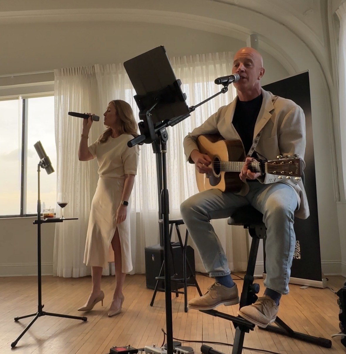 Katie singing and Ryan playing acoustic guitar during an Acoustic Affair performance.